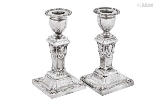 A pair of George III sterling silver dwarf or desk candlesti...