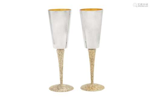 A pair of Elizabeth II modernist sterling silver parcel gilt...