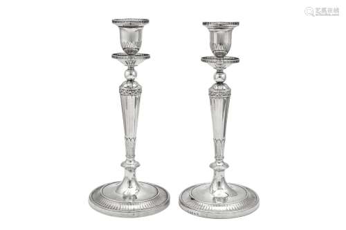 An unusual pair of George III sterling silver candlesticks, ...