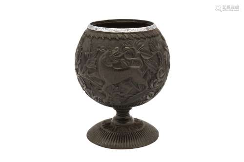 A 19th century unmarked silver mounted coconut cup, probably...