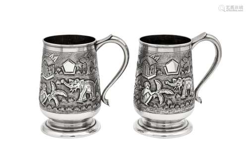 A pair of mid-20th century Anglo-Indian silver pint mugs, Bo...