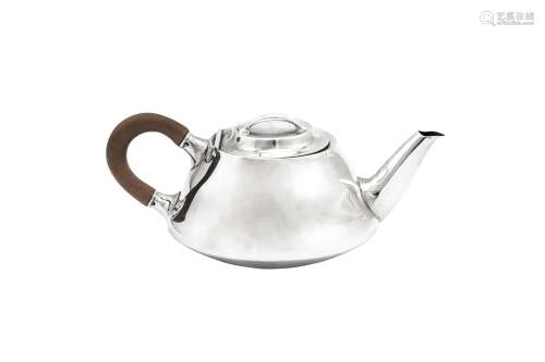 A George V 'Arts and Crafts' sterling silver bachelor teapot...