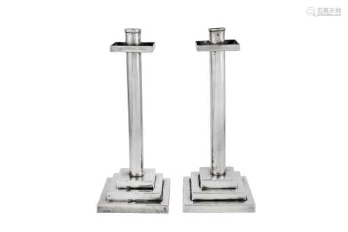 A pair of Elizabeth II modernist sterling silver candlestick...