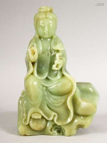 A GOOD HEAVY JADE FIGURE of a seated Guanyin, 17cm high.