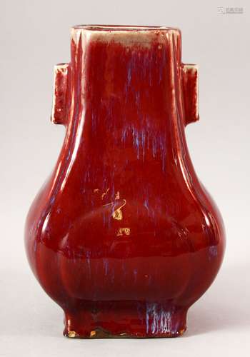 A CHINESE TWIN HANDLED RED FLAMBE VASE, 28.5cm high.