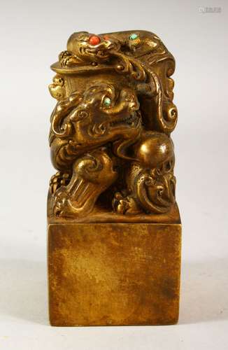 A CHINESE BRONZE SEAL, in form of a lion dog, inset with sem...