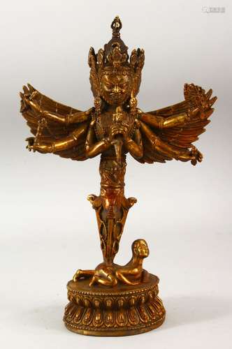 A TIBETAN GILT BRONZE MULTI ARMED DEITY FIGURE, 28cm high.