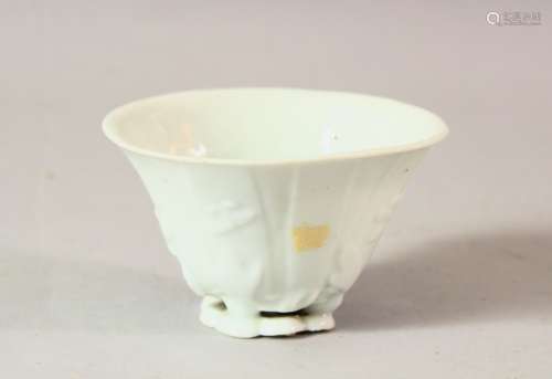 A CHINESE BLANC DE CHINE PORCELAIN LIBATION CUP, with moulde...