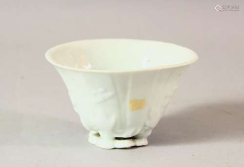 A CHINESE BLANC DE CHINE PORCELAIN LIBATION CUP, with moulde...