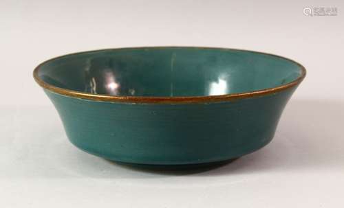 A CHINESE SONG STYLE CELADON BOWL, the centre carved with ca...