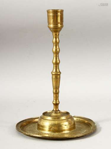 AN 18TH CENTURY OTTOMAN ENGRAVED BRASS CANDLESTICK, the base...