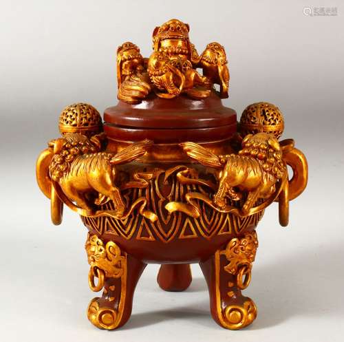 A CHINESE RED AND GILT LACQUERED WOOD TRIPOD CENSER AND COVE...