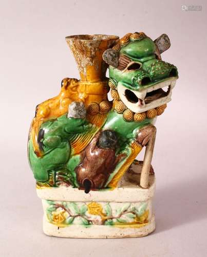 A 19TH CENTURY CHINESE SANCAI STYLE GLAZED LION DOG CANDLEST...