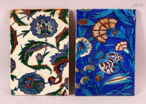 TWO IZNIK STYLE POTTERY TILES, with blue and white grounds w...