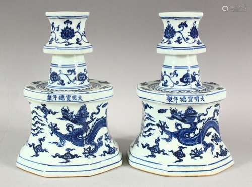 A PAIR OF CHINESE BLUE & WHITE PORCELAIN CANDLESTICKS - each...