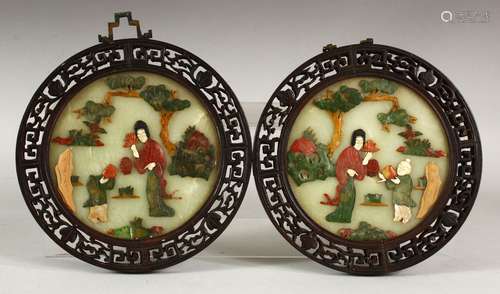 A PAIR OF CHINESE CIRCULAR HARDSTONE PANELS, each depciting ...