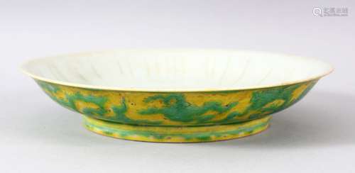 A CHINESE YELLOW GROUND PORCELAIN DRAGON DISH, the base with...