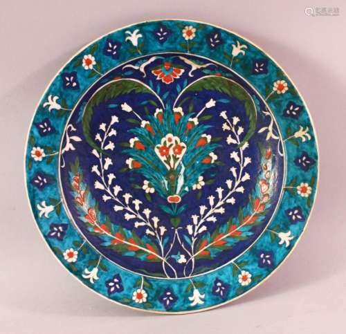 A TURKISH OTTOMAN IZNIC STYLE POTTERY PLATE, with a blue gro...