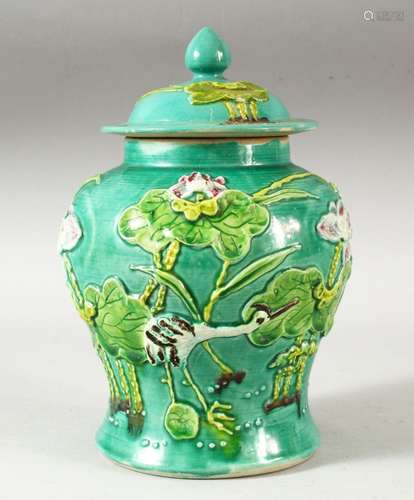 A CHINESE TURQUOISE GLAZED MOULDED JAR AND COVER, the body d...