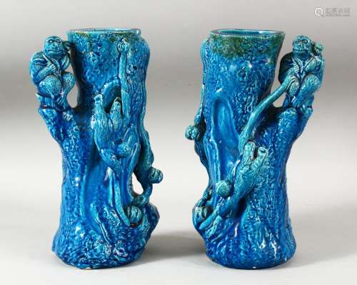A PAIR OF CHINESE TURQUOISE GLAZED POTTERY MONKEY VASES, the...