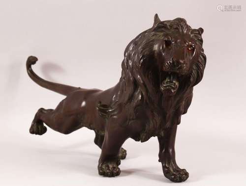 A JAPANESE MEIJI BRONZE FIGURE OF A LION, the lion in predat...