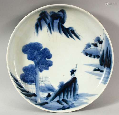 A JAPANESE BLUE AND WHITE PORCELAIN DISH, painted with a fig...