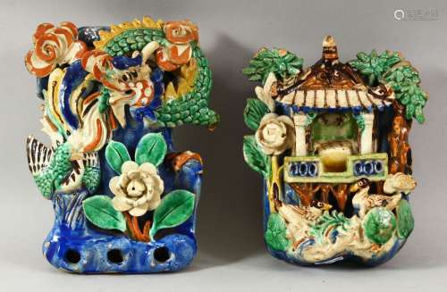 TWO CHINESE POLYCHROME POTTERY WALL POCKETS, carved with a s...