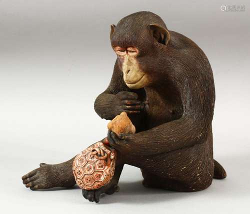 A WELL MODELLED JAPANESE POTTERY FIGURE OF A SEATED MONKEY, ...