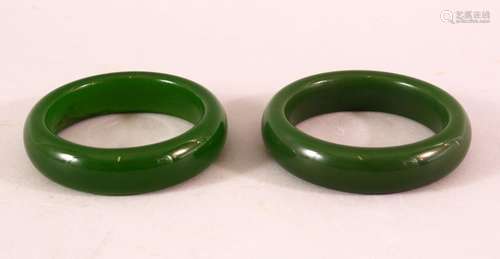 A PAIR OF CHINESE JADE BANGLES, both 8cm diameter.