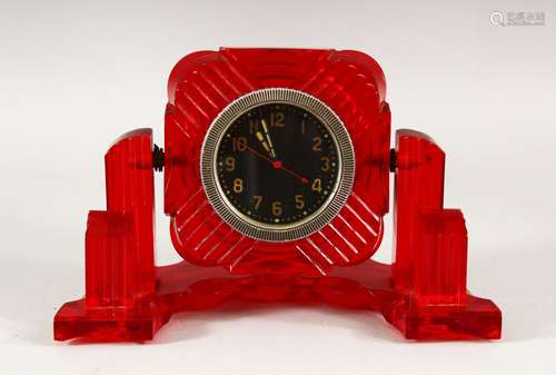 A RARE ART DECO DESIGN RED BAKELITE DESK CLOCK, 19cm wide.