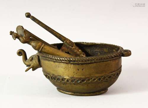 AN EASTERN BRONZE POURING VESSEL, the spout modelled as the ...