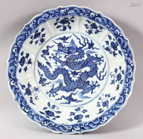 A GOOD LARGE CHINESE BLUE AND WHITE DRAGON DISH, the centre ...