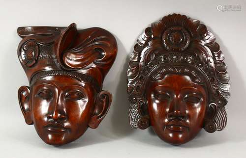 TWO INDONESIAN CARVED HARDWOOD MASKS of a male and female, 2...