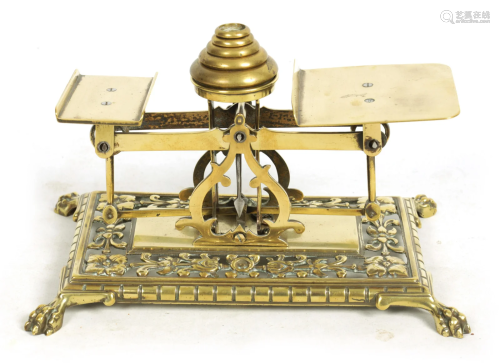A LATE 19TH CENTURY BRASS POSTAL SCALE having a set of