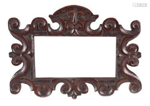 AN 18TH CENTURY CARVED OAK FRAME with scrolled corners