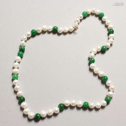 A STRING OF PEARL AND JADE BEADS with 14ct gold clasp.