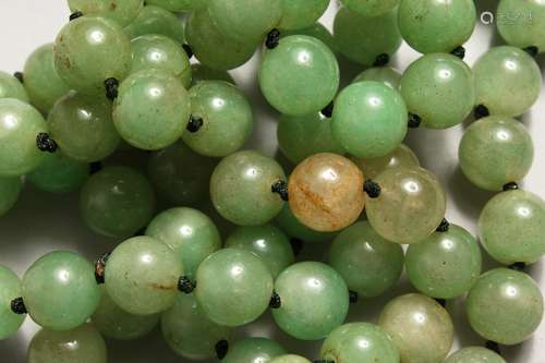 A STRING OF JADE BEADS