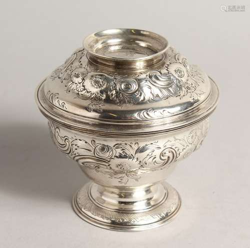 A GEORGE II CIRCULAR SUGAR BOWL AND COVER with repousse deco...