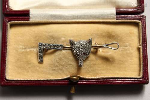 A GOLD AND DIAMOND FOX HUNTING PIN with fox's head