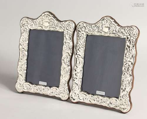 A PAIR OF SILVER REPOUSSE UPRIGHT PHOTOGRAPH FRAMES 8ins x 5...