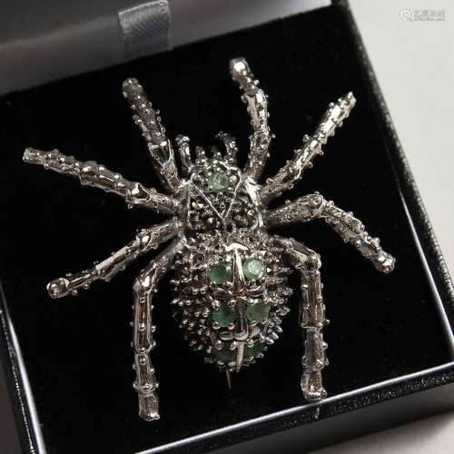 A SILVER EMERALD AND MARCASITE SPIDER BROOCH