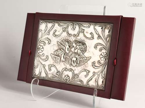 A MAROON LEATHER DESK BLOTTER, the cover with embossed silve...