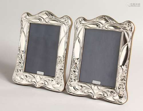 A PAIR OF SILVER ART NOUVEAU STYLE PHOTOGRAPH FRAMES. 8ins x...