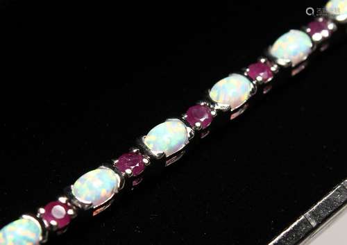 A SILVER RUBY AND OPAL LINE BRACELET