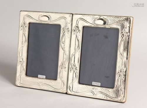 A PAIR OF SILVER ART NOUVEAU STYLE PHOTOGRAPH FRAMES. 8ins x...