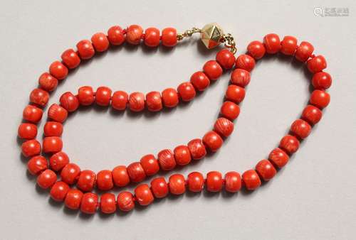 A RED CORAL NECKLACE with gold clasp.