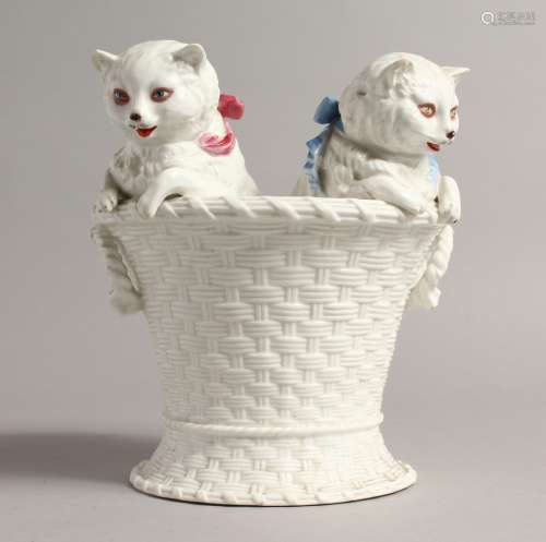 A CONTINENTAL GROUP, TWO CATS in a white basket 7ins high.