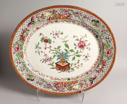 A LARGE OVAL MEAT DISH painted with flowes 20ins long