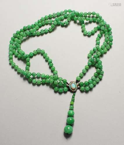 A TRIPLE ROW OF JADE BEADS with opal clasp