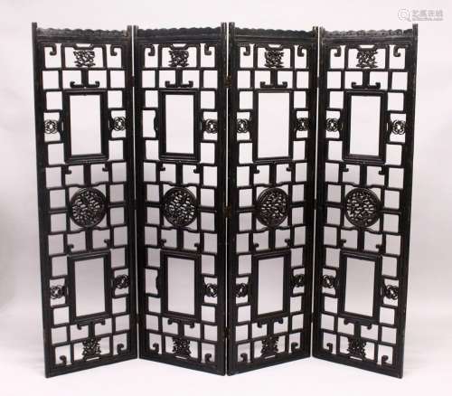 A CHINESE BLACK LACQUER FOUR SECTION CARVED WOOD FOLDING DRE...